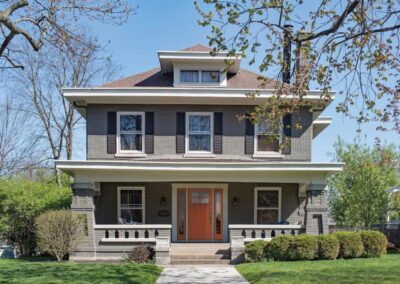 a three storey house with glass windows