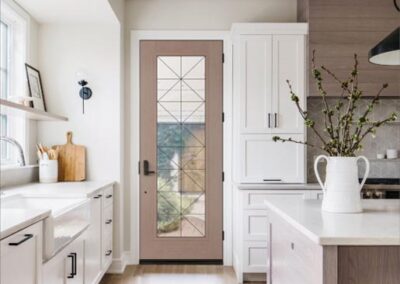 a kitchen with a hinged glass door