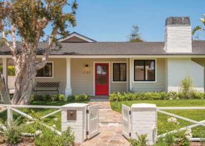 a bungalow house with a red glass door