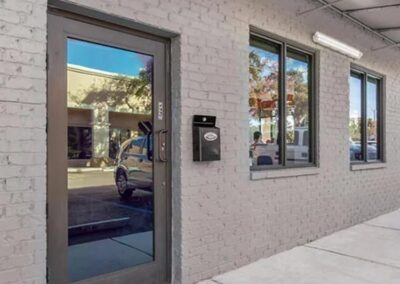 a cemented store with an outswing french door