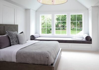 a white bedroom with casement windows