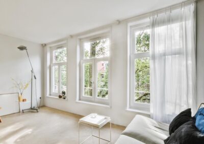 a living room with white walls and wood flooring